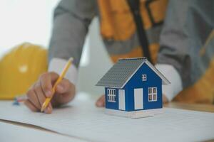 Construction and structure concept of Engineer or architect meeting for project working with partner and engineering tools on model building and blueprint in working site, contract for both companies. photo
