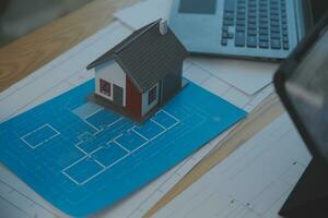 Construction and structure concept of Engineer or architect meeting for project working with partner and engineering tools on model building and blueprint in working site, contract for both companies. photo