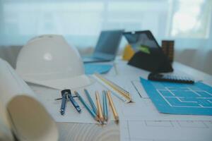 Construction and structure concept of Engineer or architect meeting for project working with partner and engineering tools on model building and blueprint in working site, contract for both companies. photo