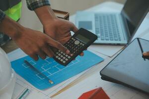 Construction and structure concept of Engineer or architect meeting for project working with partner and engineering tools on model building and blueprint in working site, contract for both companies. photo