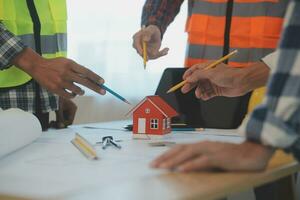 Construction and structure concept of Engineer or architect meeting for project working with partner and engineering tools on model building and blueprint in working site, contract for both companies. photo