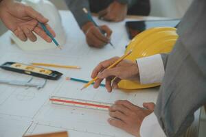 Construction and structure concept of Engineer or architect meeting for project working with partner and engineering tools on model building and blueprint in working site, contract for both companies. photo