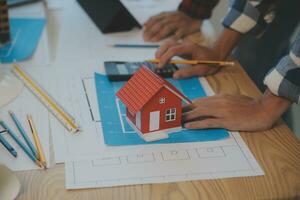 Construction and structure concept of Engineer or architect meeting for project working with partner and engineering tools on model building and blueprint in working site, contract for both companies. photo