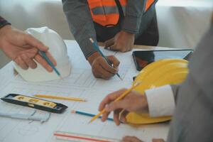 Construction and structure concept of Engineer or architect meeting for project working with partner and engineering tools on model building and blueprint in working site, contract for both companies. photo