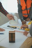 Construction and structure concept of Engineer or architect meeting for project working with partner and engineering tools on model building and blueprint in working site, contract for both companies. photo