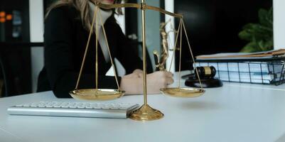 Male lawyer working with contract papers and wooden gavel on tabel in courtroom. justice and law ,attorney, court judge, concept. photo