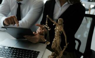 Male lawyer working with contract papers and wooden gavel on tabel in courtroom. justice and law ,attorney, court judge, concept. photo