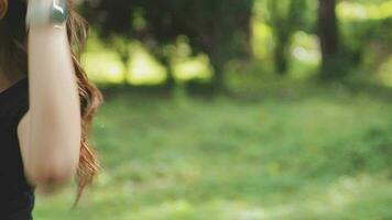 A young woman runner runs at sunset in a park in the park. video