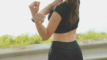 Young fitness woman runner stretching legs before run on city video