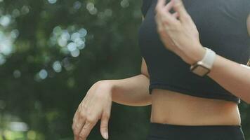 Young fitness woman runner stretching legs before run on city video