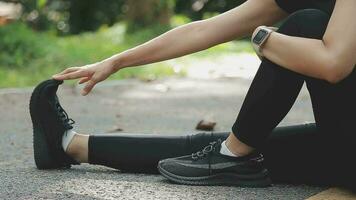 Young fitness woman runner stretching legs before run on city video