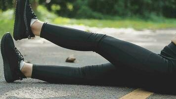 Young fitness woman runner stretching legs before run on city video