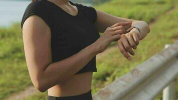 Young fitness woman runner stretching legs before run on city video