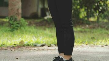 Young fitness woman runner stretching legs before run on city video