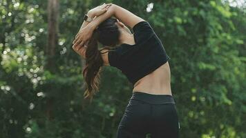 Young fitness woman runner stretching legs before run on city video