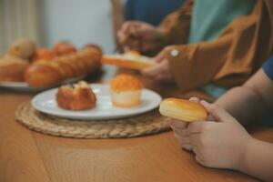 Caucasian attractive couple baking bakery with son in kitchen at home. Happy Family-father, mother and young boy having fun spending time together using ingredient making foods. Activity relationship. photo