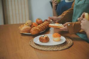 Caucasian attractive couple baking bakery with son in kitchen at home. Happy Family-father, mother and young boy having fun spending time together using ingredient making foods. Activity relationship. photo