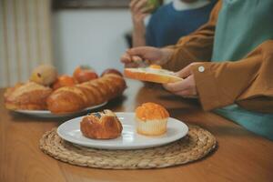 Caucasian attractive couple baking bakery with son in kitchen at home. Happy Family-father, mother and young boy having fun spending time together using ingredient making foods. Activity relationship. photo