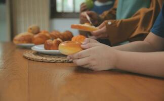 Caucasian attractive couple baking bakery with son in kitchen at home. Happy Family-father, mother and young boy having fun spending time together using ingredient making foods. Activity relationship. photo