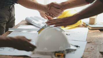 Image of team engineer checks construction blueprints on new project with engineering tools at desk in office. video