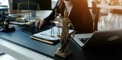 Male lawyer working with contract papers and wooden gavel on tabel in courtroom. justice and law ,attorney, court judge, concept. photo