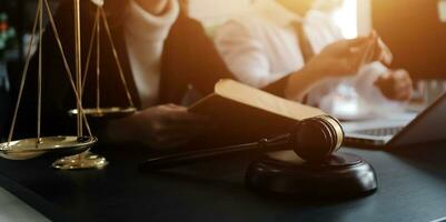 Male lawyer working with contract papers and wooden gavel on tabel in courtroom. justice and law ,attorney, court judge, concept. photo