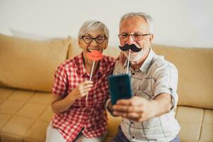 Happy mature couple is having fun at home. photo