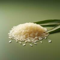 Rice grains and leaves on green background photo