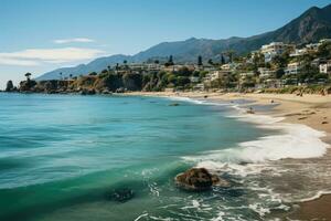 Beach view showing calm waves crashing on golden sand on a perfect summer day. View of the coastline in the town of Malibu, California. photo