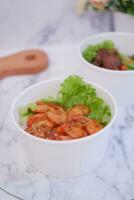 Shrimp salad in white bowlle table background, top view photo