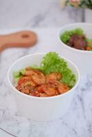 Shrimp salad in white bowlle table background, top view photo