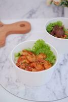 Shrimp salad in white bowlle table background, top view photo