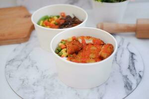 Fried chicken with sweet pepper and tomato in white bowl photo