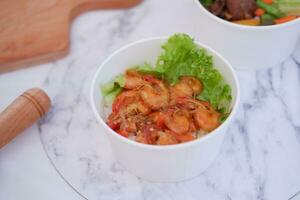 Shrimp salad in white bowlle table background, top view photo