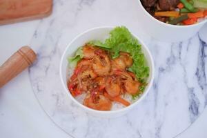 Shrimp salad in white bowlle table background, top view photo