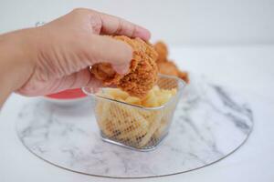 French fries, fried chicken and ketchup on white marble table. photo