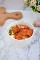 Fried chicken with sweet pepper and tomato in white bowl photo