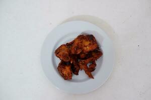Fried chicken on a white plate and white background photo