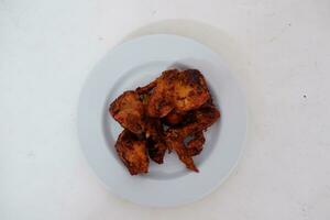Fried chicken on a white plate and white background photo
