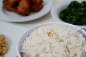 Instant noodle with fried chicken and rice on white plate photo