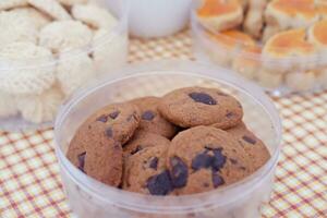 Homemade cookies in plastic box on tablecloth. Selective focus. photo