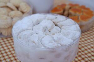 Coconut cookies in a glass bowl on checkered tablecloth photo