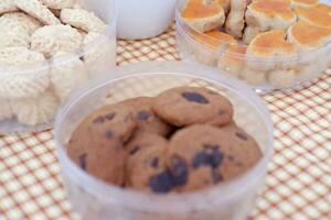 Homemade cookies in plastic box on tablecloth. Selective focus. photo