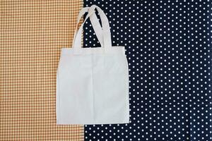 White cotton bag on a blue and white polka dot background. photo