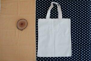 White cotton bag on a blue and white polka dot background. photo