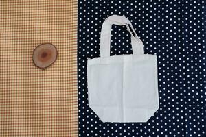 White cotton bag on a blue and white polka dot background. photo