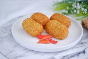 Fried croquettes on a white plate. Selective focus. photo