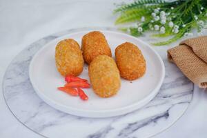 Fried croquettes on a white plate. Selective focus. photo