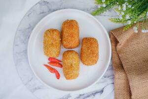 Fried croquettes on a white plate. Selective focus. photo