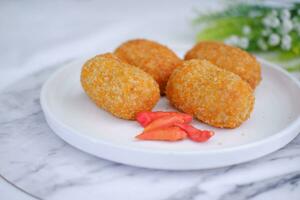 Fried croquettes on a white plate. Selective focus. photo